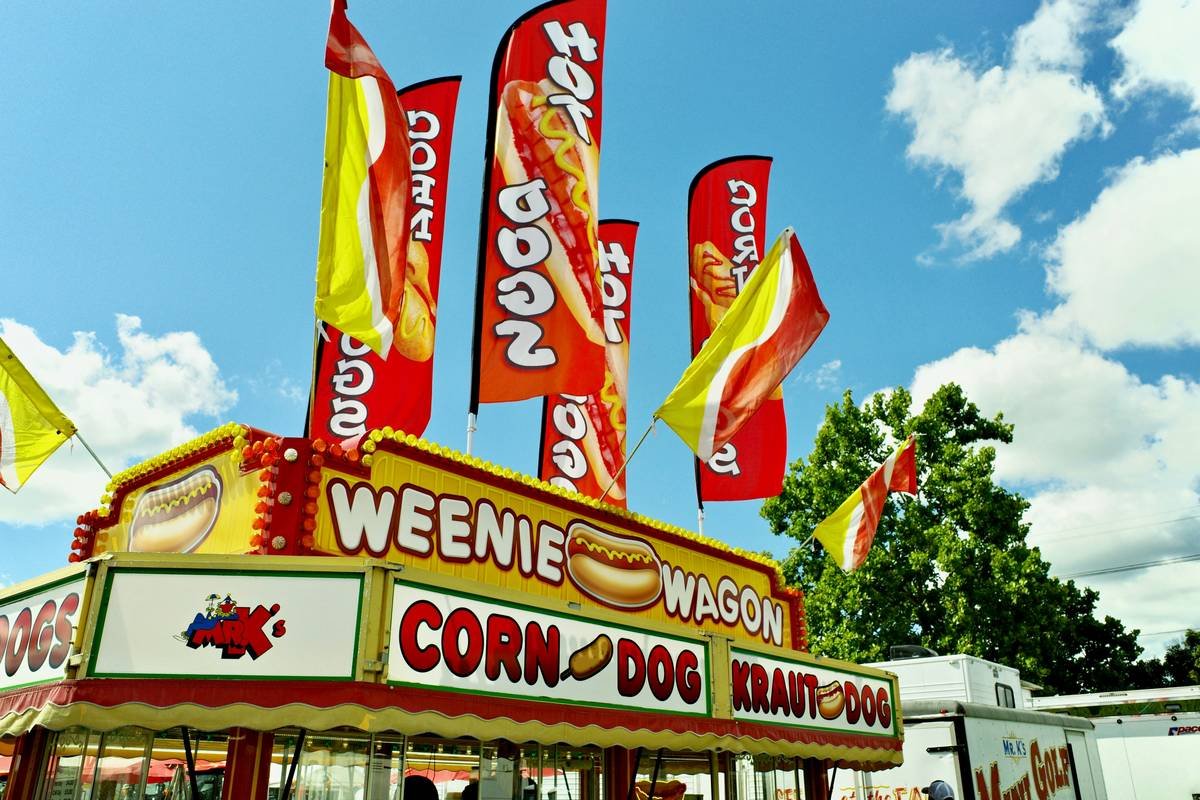 A "weenie wagon" food stand with hot dog flags.